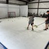 Hockey player practicing on Skate Anytime synthetic ice in garage