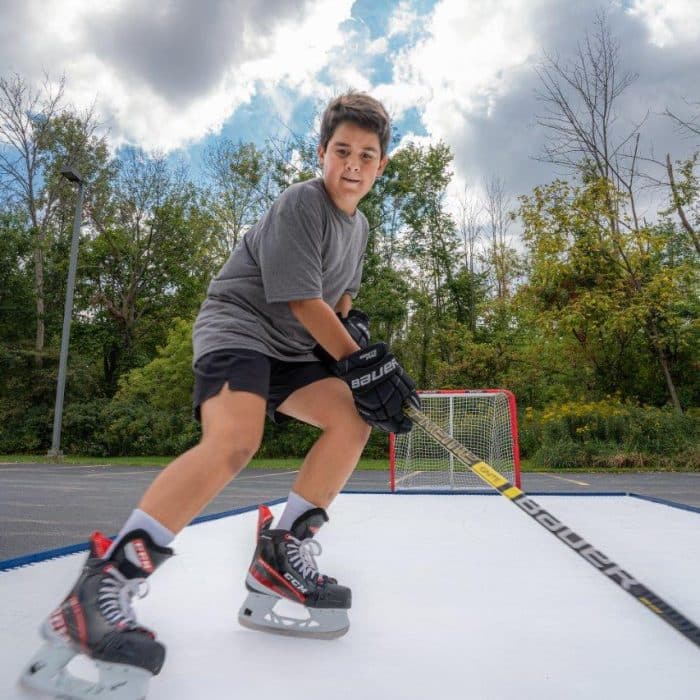 Hockey player excelling in an intense workout on Skate Anytime Synthetic Ice, achieving remarkable results.