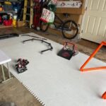 Synthetic ice hockey training setup inside a garage using Skate Anytime panels.
