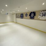 Premium basement hockey training area with Skate Anytime synthetic ice panels installed.