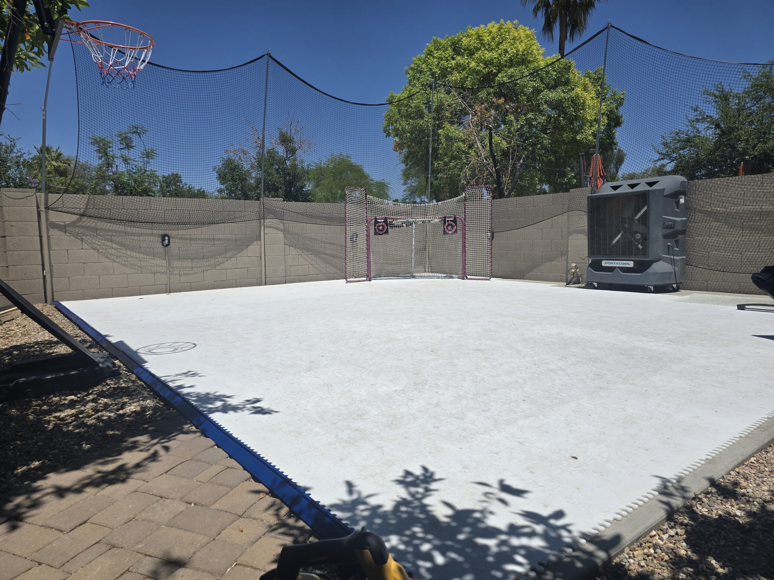 Backyard synthetic ice rink for year-round hockey and skating