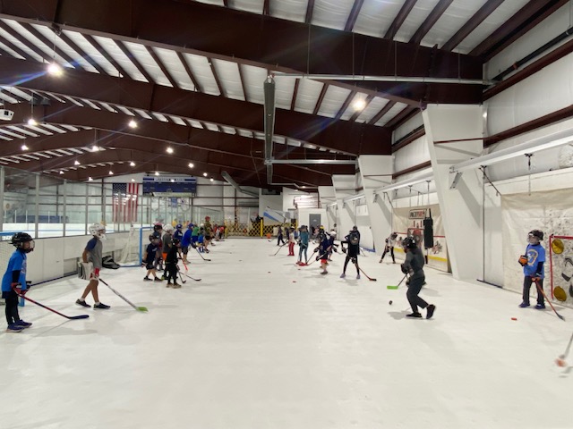Synthetic ice training arena for hockey practice and skill development