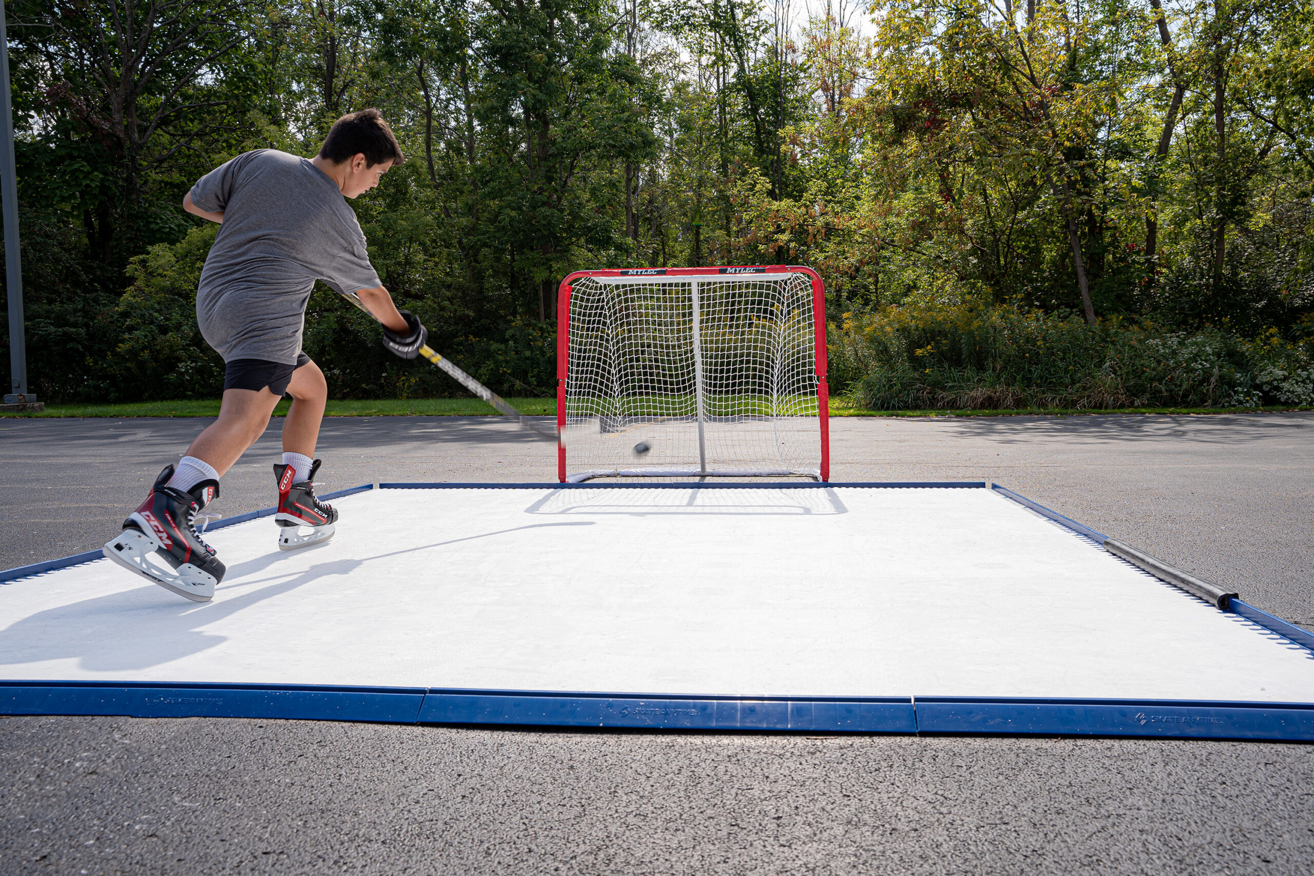 Skate Anytime 10' x 10' synthetic ice home training rink with perimeter edges, ideal for skating and hockey skills practice at home.